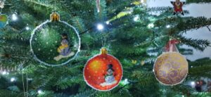 Green and orange snowman on the tree- stitched on plastic aida