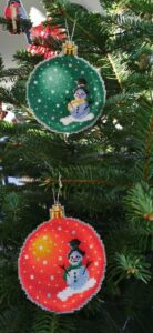 Green and orange snowman - stitched on plastic aida