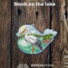 Stork on the lake on wood